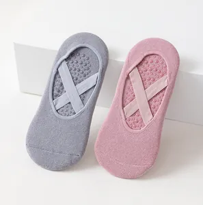 Detailed view of non-slip women's yoga socks featuring cross straps for Pilates and fitness