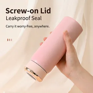 Close-up of a pink 304 vacuum insulated water bottle being held by a hand.