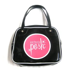 Detalle macro de bolso de cuero PU negro brillante con el logo rosa Perfectly Posh