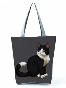 Full view of charcoal tote bag featuring a realistic black and white cat print