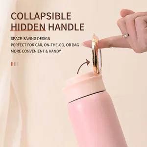 Close-up of the foldable hidden handle on a pink insulated vacuum flask