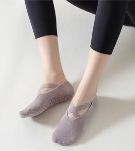 Light purple yoga socks with cross straps and non-slip bottom for pilates and fitness