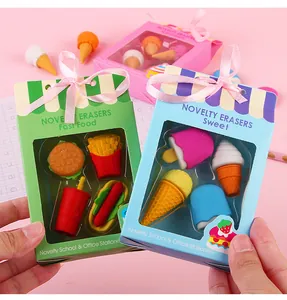 Detalle de gomas de borrar con forma de comida en caja de regalo colorida