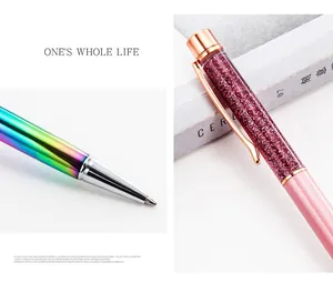 Detailed macro view of stylish glitter quicksand and rainbow metallic ballpoint pens.