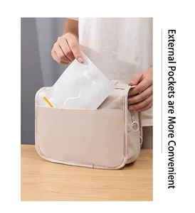 Close-up showing the external front pocket of a beige waterproof hanging wash bag