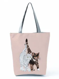 Close-up of cute cat print on pink polyester tote bag with grey straps