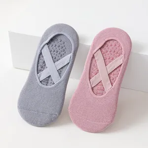 Non-slip women's yoga socks with cross straps for Pilates and fitness exercises