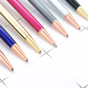 Set of elegant candy-colored metal ballpoint pens with rose gold accents on white grid.