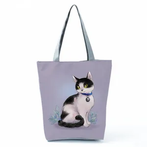 Stylish purple tote bag featuring an adorable black and white cat illustration.