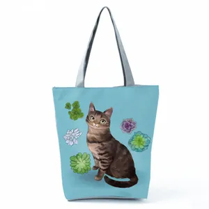 Stylish light blue tote bag featuring a cute cat and succulent illustration print