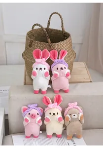 Close-up of cute plush animal keychains featuring rabbits and bears with headbands.
