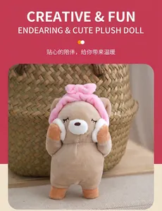 Detail showing a cute plush bear keychain wearing a pink headband and holding face puffs