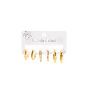 Set of three pairs of geometric gold hoop earrings in stainless steel on a white card