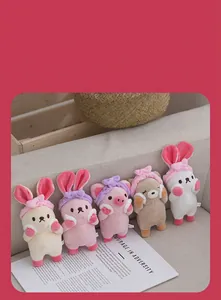 Detail of cute plush animal keychains featuring rabbits, a pig, and a bear with headbands