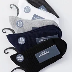 Detail view of multi-color combed cotton crew socks with ribbed texture and tags