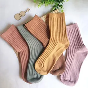 Detailed view of colorful vertical ribbed mid-calf cotton socks in earth tones