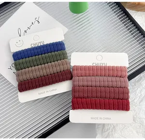 Detailed view of high-elasticity thick towel hair ties in multiple colors on white cards