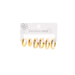 Set of three pairs of gold-plated stainless steel hoop earrings with crystal accents.