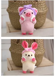 Detailed view of cute plush pig and rabbit pendants with soft headbands and sweet expressions