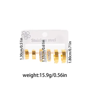 Detail showing three pairs of gold stainless steel hoop earrings with size markings