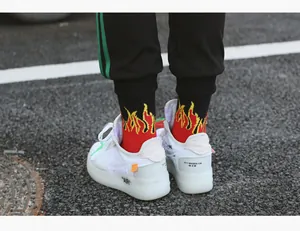 Detailed back view of mid-calf socks featuring vibrant red and yellow flame patterns