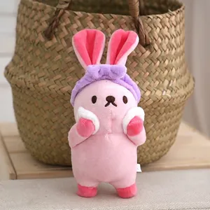 Cute pink plush rabbit wearing a purple headband as a soft bag charm and keychain.