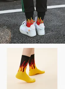 Macro detail view of cotton crew socks featuring a vibrant fire flame pattern design