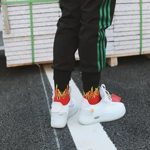 Unisex cotton socks featuring vibrant red and yellow flame patterns for a street style look.