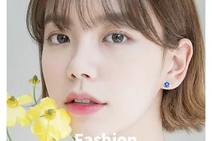 Close-up of a blue flower s925 silver stud earring worn by an elegant Asian model