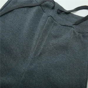 Close-up detail of dark grey fleece joggers with adjustable drawstring waistband
