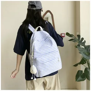 Blue and white gingham backpack for girls featuring a bow detail and plush doll charm