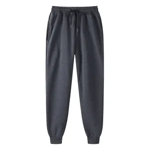 Close-up of charcoal grey fleece joggers with elastic drawstring waist and ribbed cuffs