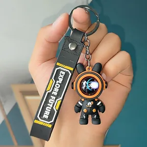 Detailed view of a trendy black astronaut bear keychain with an Explore Future printed strap
