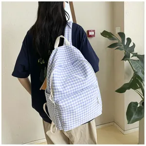A back view of a blue and white checkered school backpack with sweet bow embroidery.