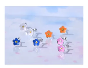 Close-up of colorful S925 silver flower ear studs with secure screw-back closures.