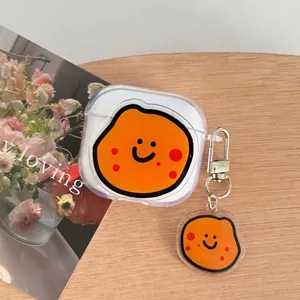 Detail view of transparent AirPods case featuring a cute orange character with keychain