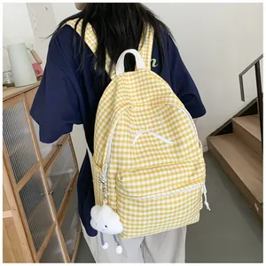 Yellow and white gingham backpack with bow detail and cloud charm shown on a model