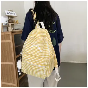 Back view of a student wearing a yellow gingham backpack with white bow detail