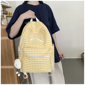 Detailed view of yellow gingham backpack with white bow embroidery and cloud charm