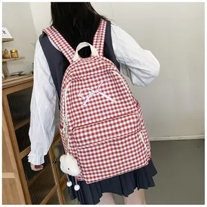Back view of a stylish red checkered backpack with white bow and cloud plush accessory