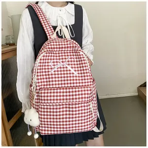 Red and white gingham school backpack featuring a white bow pattern and fluffy cloud keychain