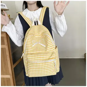 Japanese style yellow gingham backpack with bow detail worn by a student.