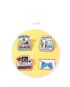 Detailed view of medical enamel pins featuring lab tech and sonographer designs