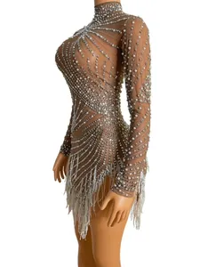 Detailed view of sheer mesh Latin dance dress with pearls, rhinestones and tassels