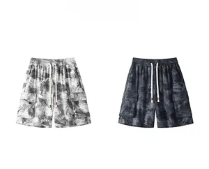 Close-up view of tie-dye retro men's cargo shorts in light and dark gray patterns