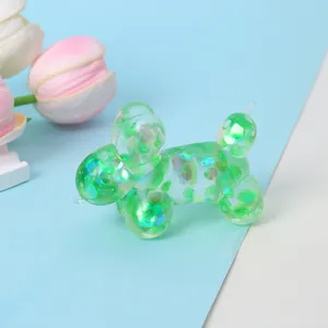 Detail showing the iridescent sequins inside a green translucent balloon dog squeeze toy