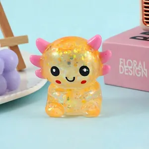Macro view of a glitter-filled axolotl squeeze toy featuring a cute smiling face.