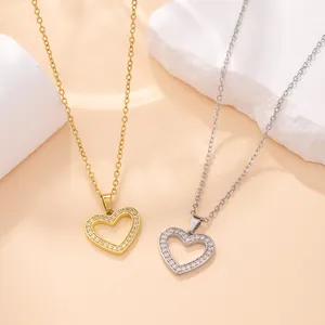 Detailed macro view of gold and silver heart-shaped pendants with sparkling stones