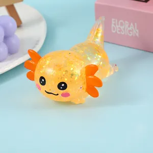 Close-up detail of a cute glitter orange axolotl squeeze toy for stress relief