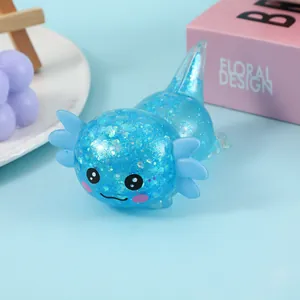 Detail view of a cute blue glittery axolotl squishy toy made of soft TPR material